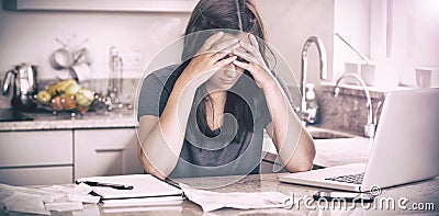 Stressed woman looking down at bills Stock Photo