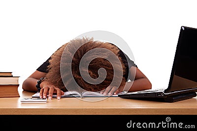 Stressed young black woman, sitting at a table Stock Photo