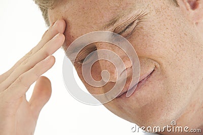 Stressed young businessman with hand on forehead Stock Photo