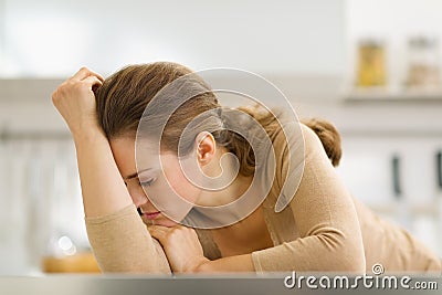 Stressed young housewife in kitchen Stock Photo