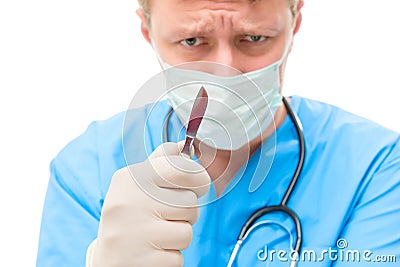 Stressful concentrating surgeon with a scalpel Stock Photo