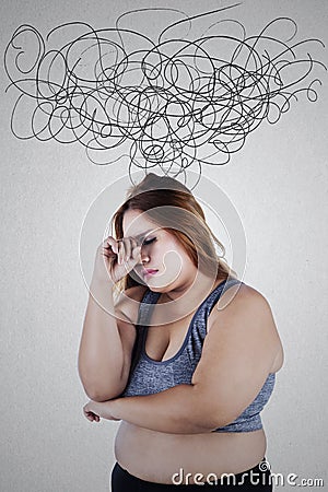 Stressful overweight woman with crumpled sign Stock Photo