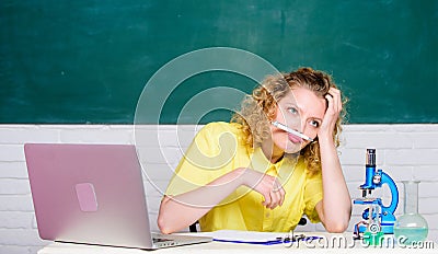 Stressful student life. Stressful day. Teacher stressful occupation. Girl emotional with laptop and microscope working Stock Photo