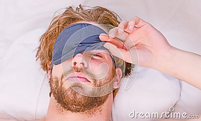 Stretch after wake up in the morning. Man feeling back ache in the bed after sleeping. Waking up stretching. Stock Photo