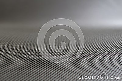 Stretched grey mesh textured polyester fabric. Stock Photo