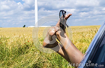 Stretching feet out of the car Stock Photo