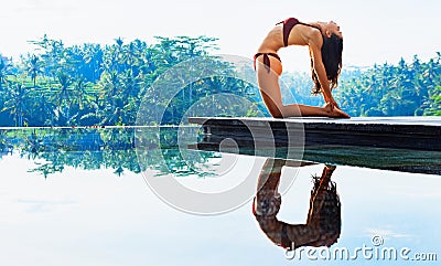 Young yoga woman stretching back in ustrasana camel pose Stock Photo