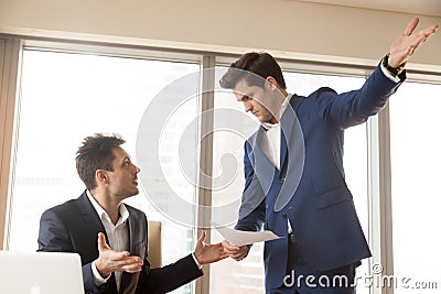 Strict boss firing incompetent employee for bad work at workplac Stock Photo