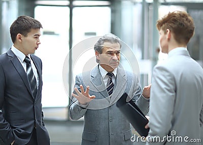Strict boss talking with an employee.photo on blurred office background Stock Photo