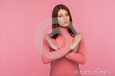 Strict bossy woman with brown hair in pink sweater showing x sign with hands, there is no way more, hopelessness Stock Photo