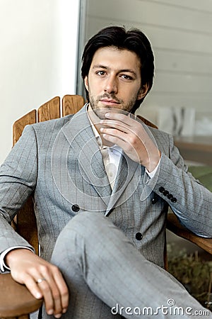 Strict male portrait. Groom in a gray wedding suit Stock Photo