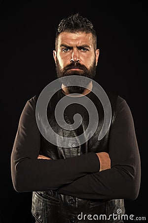 Strict mature face. Facial hair. Male face. Handsome face. Man with beard in black leather clothes. Man confident and Stock Photo