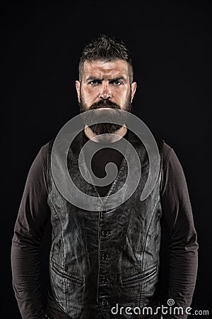 Strict mature face. Facial hair. Male face. Handsome face. Fashion model. Man with beard in black leather clothes. Man Stock Photo