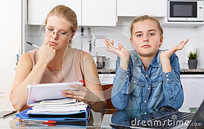 Strict mother checking poorly done home task Stock Photo