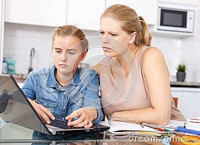 Strict mother checking poorly done home task Stock Photo