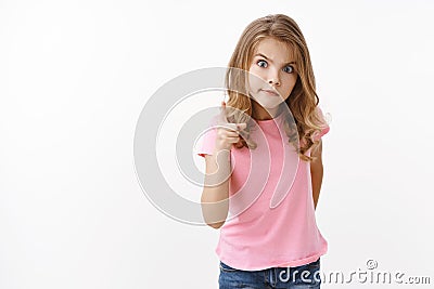 Strict serious-looking young blond little girl child, shaking one finger angry stare camera scolding younger brother for Stock Photo