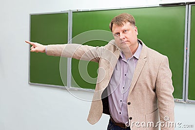 A strict teacher shows the student the exit to the door Stock Photo