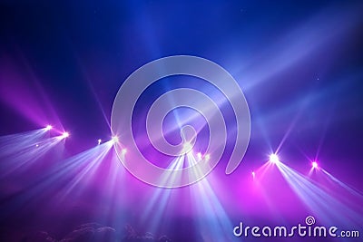 Striking contrast of purple and blue searchlights against the smoky backdrop. Stock Photo