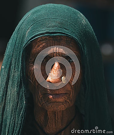 Striking portrait of an elderly Indian woman gazing at the camera with a wise look Editorial Stock Photo