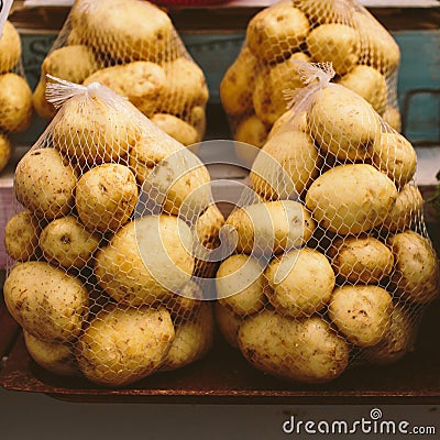 String bags with packaged fresh pure potatoes Stock Photo