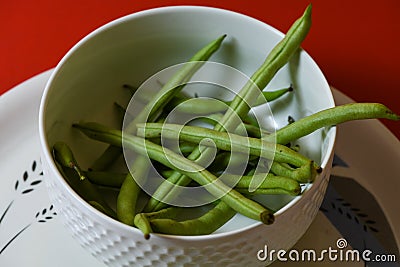 String beans seeds closeup on isolated red background Stock Photo