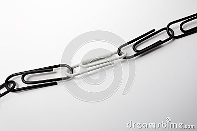 String of paperclips with one not fitting in. Symbolic representation of not fitting in the group or feeling excluded. Be differ Stock Photo