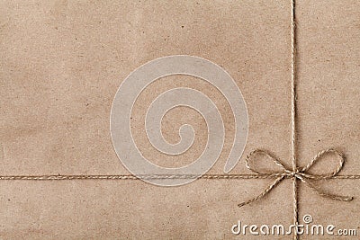 String or twine tied in a bow on kraft paper Stock Photo