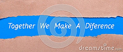 A strip of blue paper with the words TOGETHER WE MAKE A DIFFERENCE between the brown paper. View from above Stock Photo