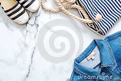 Striped casual clothing on marine style, flat lay composition on marble background. Lifestyle of beauty blogger, millennial tender Stock Photo