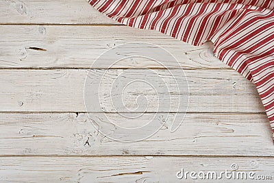 Striped kitchen napkin in the corner of wooden planks background Stock Photo