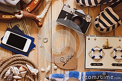 Striped slippers, camera, phone and maritime decorations, background Stock Photo