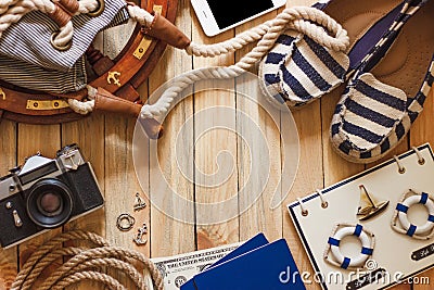 Striped slippers, camera, phone and maritime decorations, wooden background Stock Photo