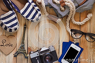 Striped slippers, camera, phone and miniature of Eiffel Tower, top view Stock Photo
