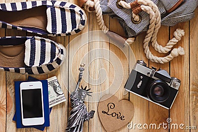 Striped slippers, camera, phone and miniature of the statue of liberty, top view Stock Photo