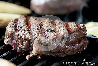 Striped steak on a grill close up Stock Photo