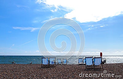Striped deckchairs on the beach in Brighton, England Stock Photo