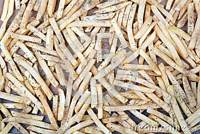 The strips of potatoes on a baking sheet sprinkled with salt pe Stock Photo