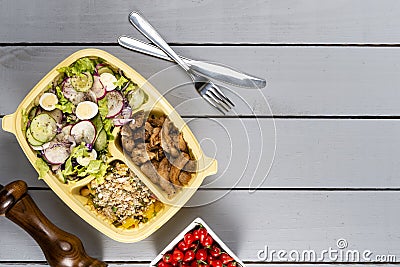 Strips of sauteed chicken and vegetables with vegetable farofa. Brazilian lunch box. Ahead meal preparation or dieting concept. t Stock Photo