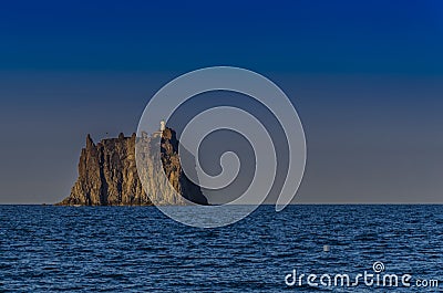 The Strombolicchio and its lighthouse in front of the island stromboli italy Stock Photo