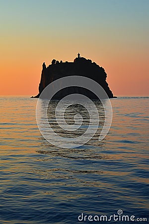 Strombolicchio with lighthouse, sunset at the island, Stromboli volcanoes, calm sea surface, Italy, Europe Stock Photo