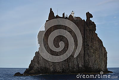 Strombolicchio, sea stack of volcanic origin, Aeolian Islands, Sicily, Italy, with lighthouse Stock Photo