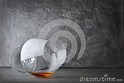 Strong alcoholic drink cognac in lying sniffer glass for tasting Stock Photo