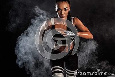 A strong athletic, female sprinter, running at sunrise wearing in the sportswear, fitness and sport motivation concept Stock Photo