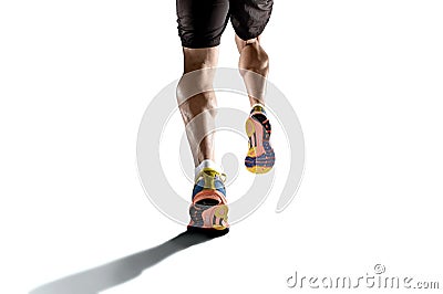 Strong athletic legs with ripped calf muscle of young sport man running isolated on white background Stock Photo