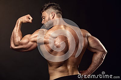 Strong Athletic Man Fitness Model posing back muscles, triceps, Stock Photo