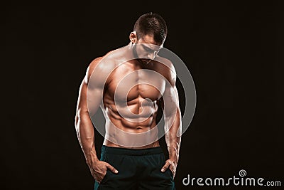 Strong Athletic Man - Fitness Model showing his perfect back isolated on black background with copyspace Stock Photo