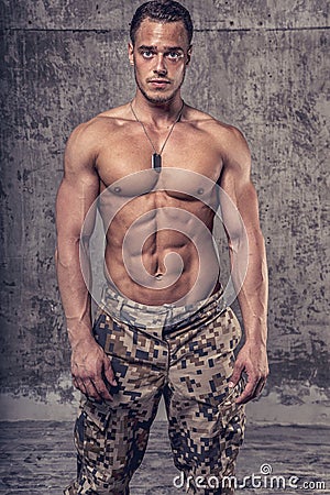 Strong athletic man with naked body in military pants Stock Photo