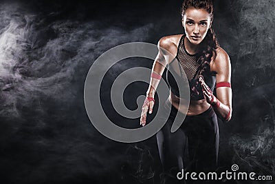 A strong athletic, woman sprinter, running on black background wearing in the sportswear, fitness and sport motivation Stock Photo