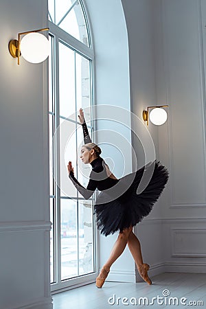 strong ballerina in black tutu ballet skirt and leotard Stock Photo