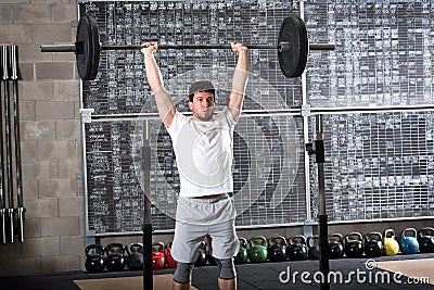 Strong bodybuilder lifting heavy barbell Stock Photo